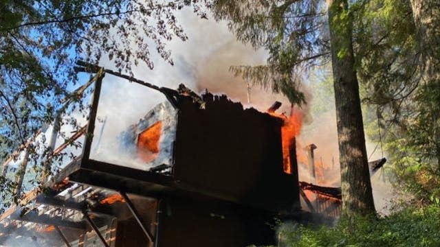 Firefighters work to extinguish structure fire in North Bend