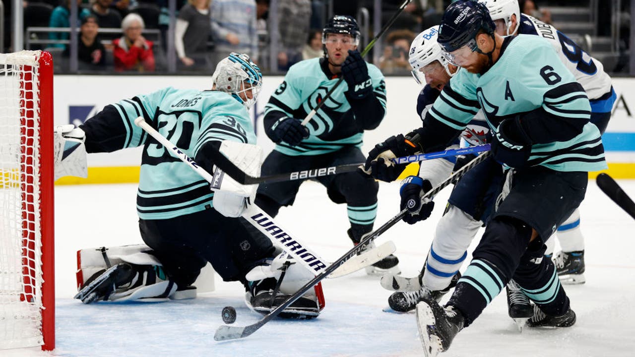 Seattle Kraken goalie Martin Jones, left, and Carson Soucy