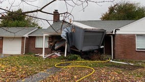 Driver pulled out of truck after it crashes into home near Green Lake