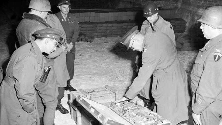 USA/Germany: Gen. Dwight D. Eisenhower, Supreme Allied Commander, and Gen. Omar N. Bradley, CG, 12th Army Group, examine a suitcase of silverware, part of German loot stored in Merkers salt mine, 12 April, 1945