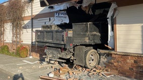 PHOTOS: Dump truck crashes through Maple Valley business