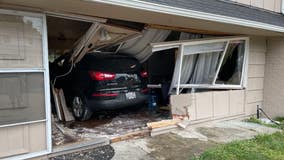 PHOTOS: Crews investigate after car crashes through home in Kent