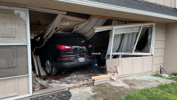 PHOTOS: Crews investigate after car crashes through home in Kent