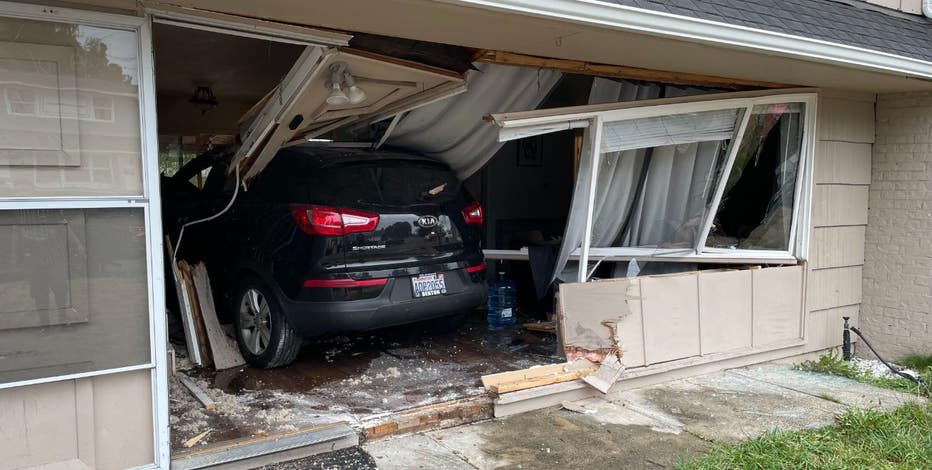 PHOTOS: Crews investigate after car crashes through home in Kent