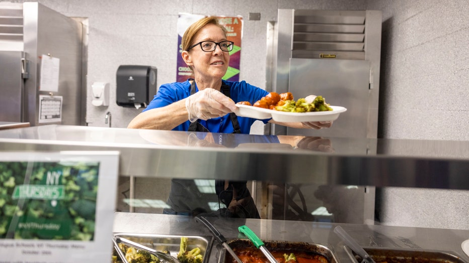 Woman serving lunch at high school