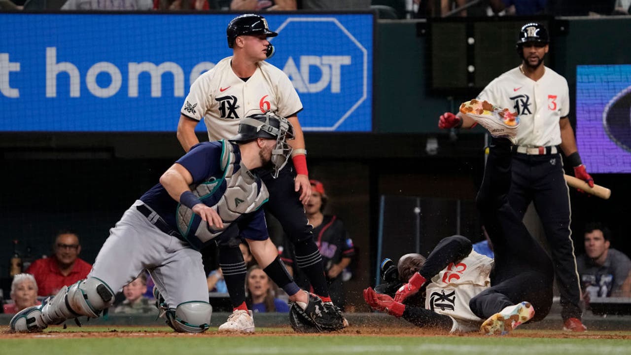 Jonah Heim of the Texas Rangers walks to the plate while taking on News  Photo - Getty Images