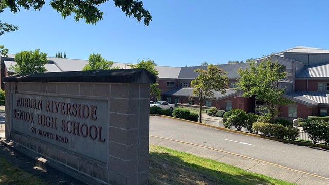 Police are investigating videos showing fights that happened 3 days before masked group got into Auburn school