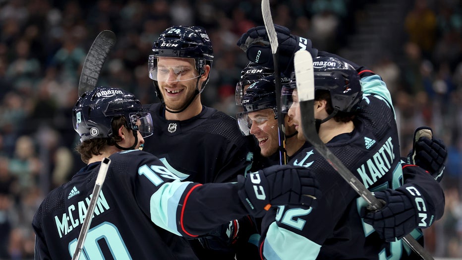 seattle kraken players celebrate goals