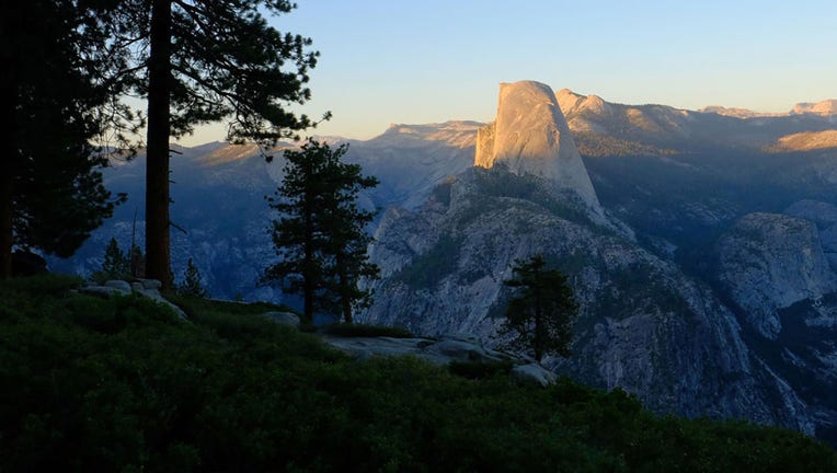 FILE - The setting sun casts light and shadow across the face of Half Dome in Yosemite National Park on Aug. 4, 2021. The view of Half Dome is from Washburn Point along Glacier Point Road. (Mark Hume/Chicago Tribune/Tribune News Service via Getty Images)