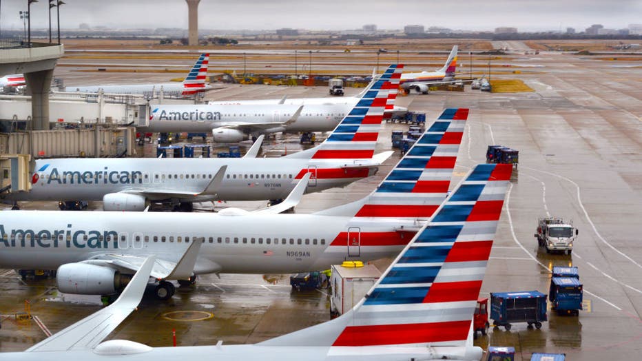 planes parked at airport gates