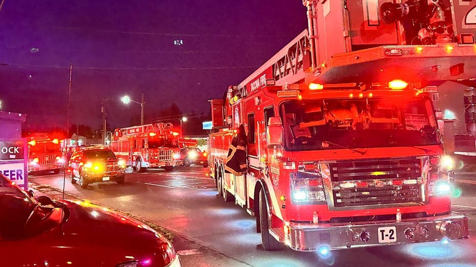 multiple firetrucks with lights flashing parked near a commercial apartment fire in Tacoma Wednesday night