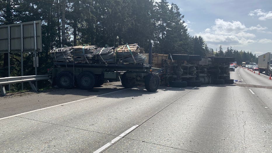overturned military truck on freeway
