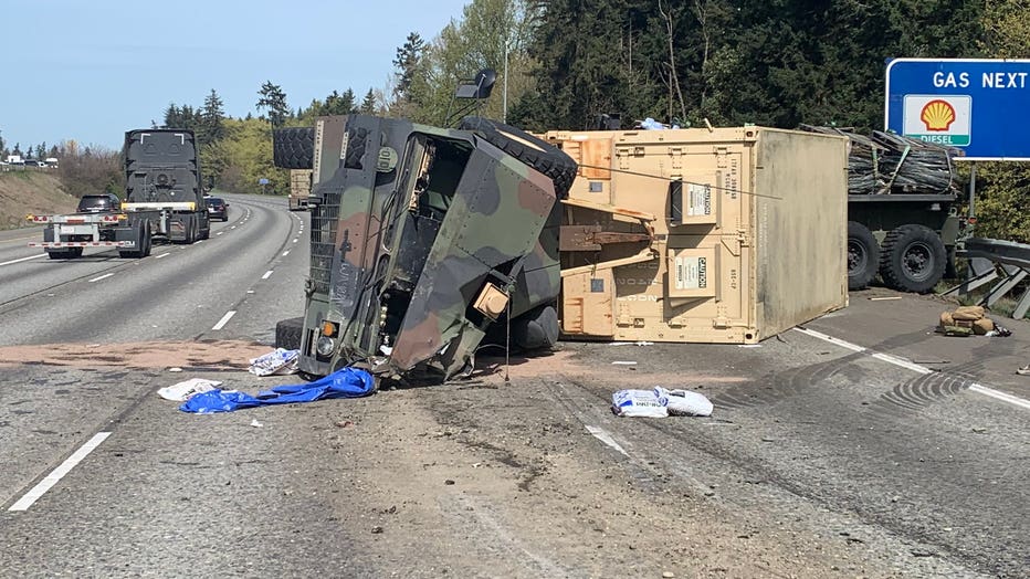 overturned military truck on freeway