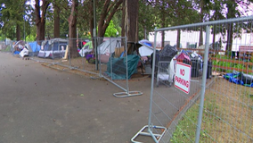 'Caged in like animals': King County sets up fencing around homeless encampment in Burien