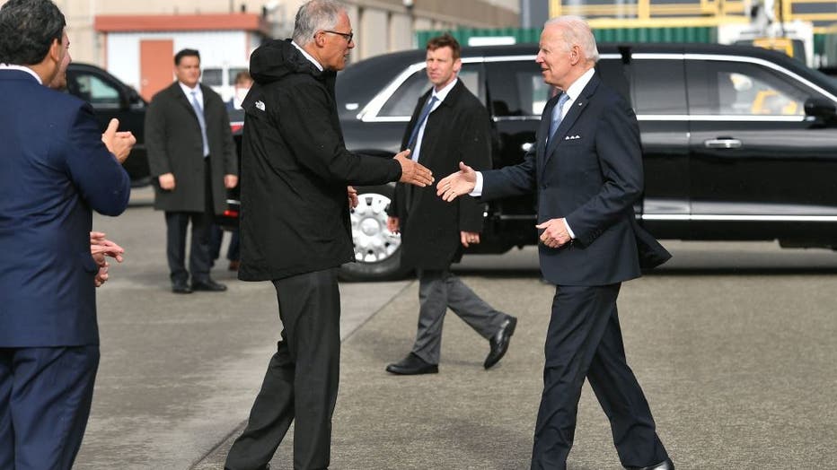 president biden shakes hands with washington governor jay inslee photo