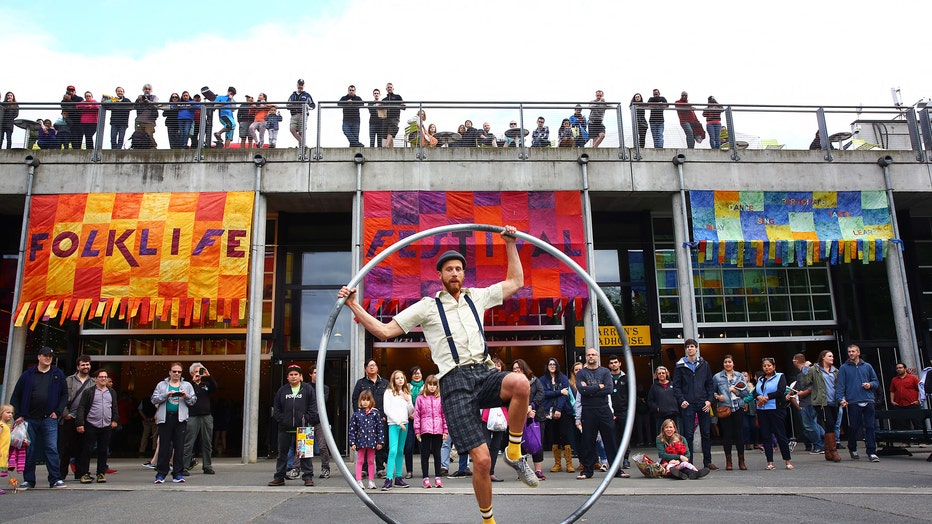 man spins on his cyr wheel during a festival