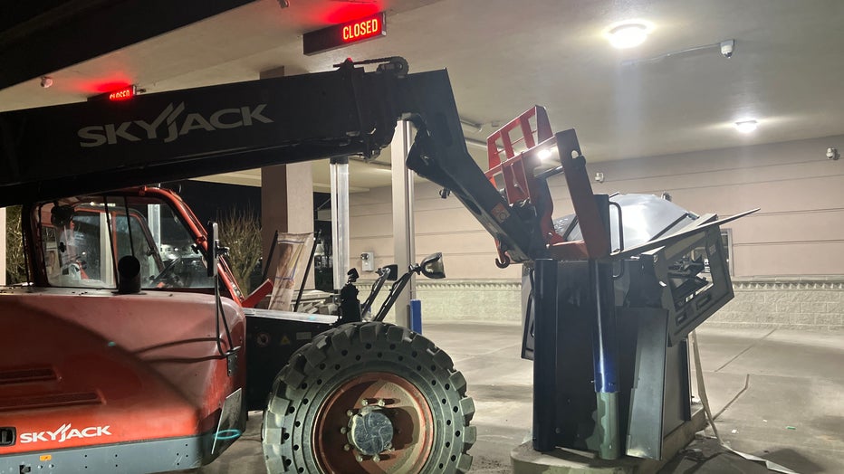 forklift with lights on in parking lot