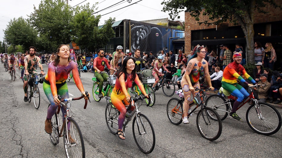 naked cyclists riding in a parade