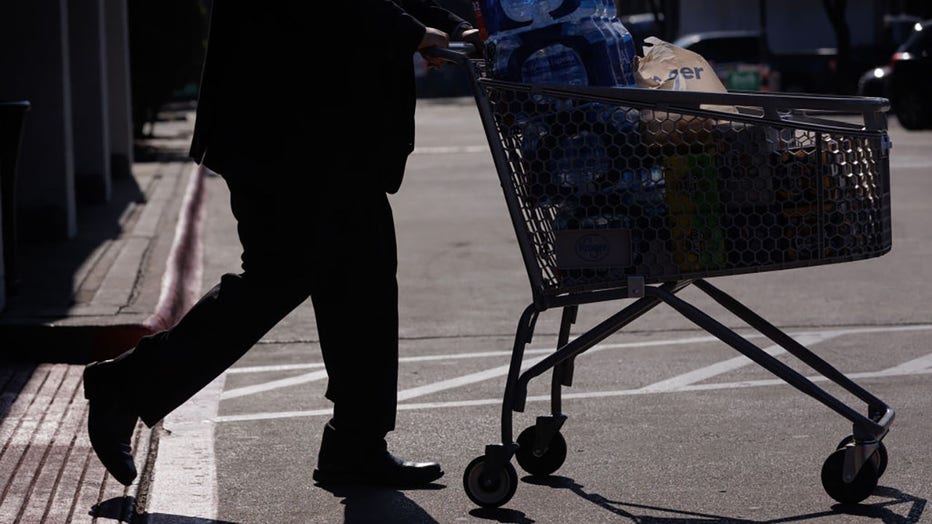 FILE - A customer pushes a shopping cart outside a Kroger grocery store in Dallas, Texas, on Feb. 21, 2024. Photographer: Shelby Tauber/Bloomberg via Getty Images