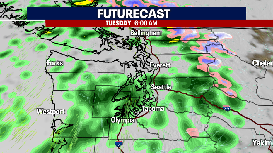 Cool showers persist Tuesday with breezy wind.