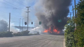 Brush fire engulfs semi trucks, power lines along SR 99 in Seattle