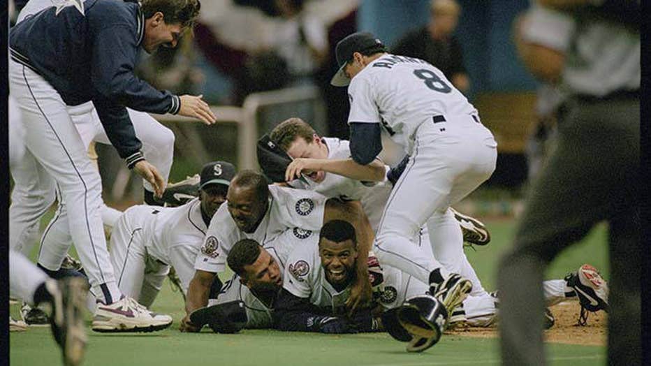 mariners players and ken griffey jr in a pile on field