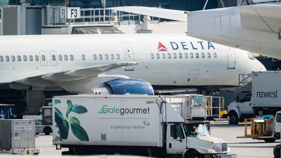 gate gourmet food truck next to a plane