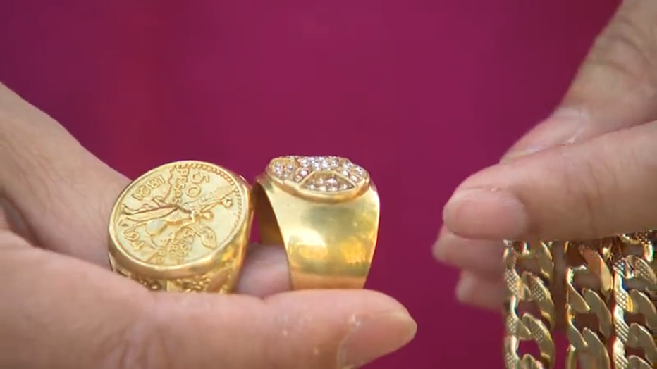 person holding gold rings and bracelets