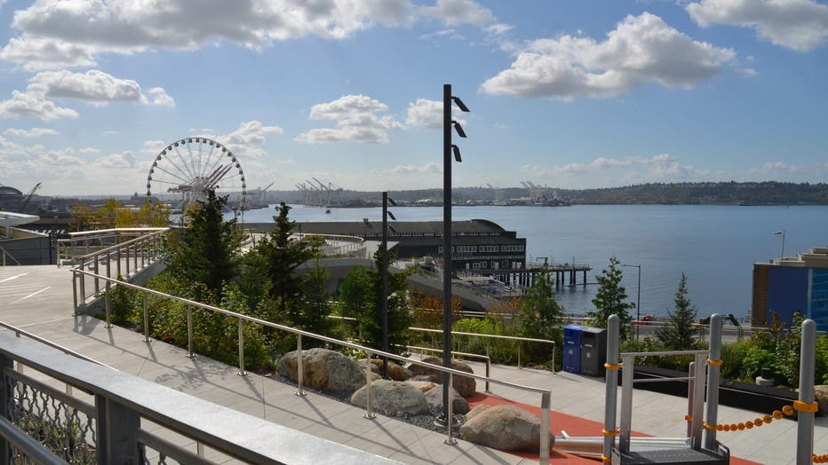 water ferris wheel elliott bay ramp blue skies clouds pathway seattle