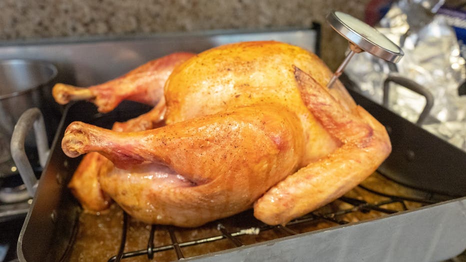 cooked turkey on a rack in a pan