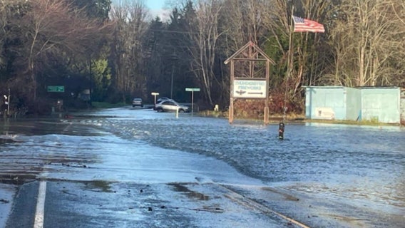 Heavy rains and winds flood roads, topple trees, doubling damage from bomb cyclone