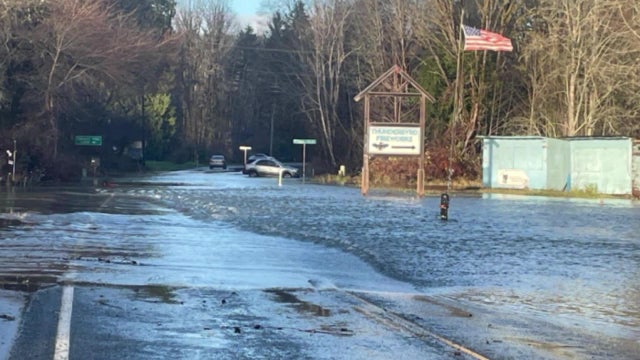 Heavy rains and winds flood roads, topple trees, doubling damage from bomb cyclone