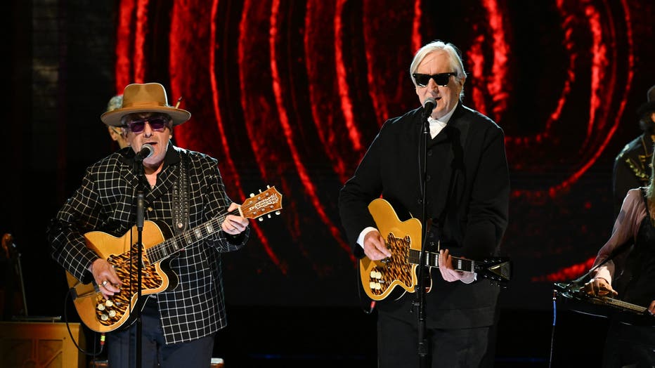 elvis costello and bone burnett perform on stage