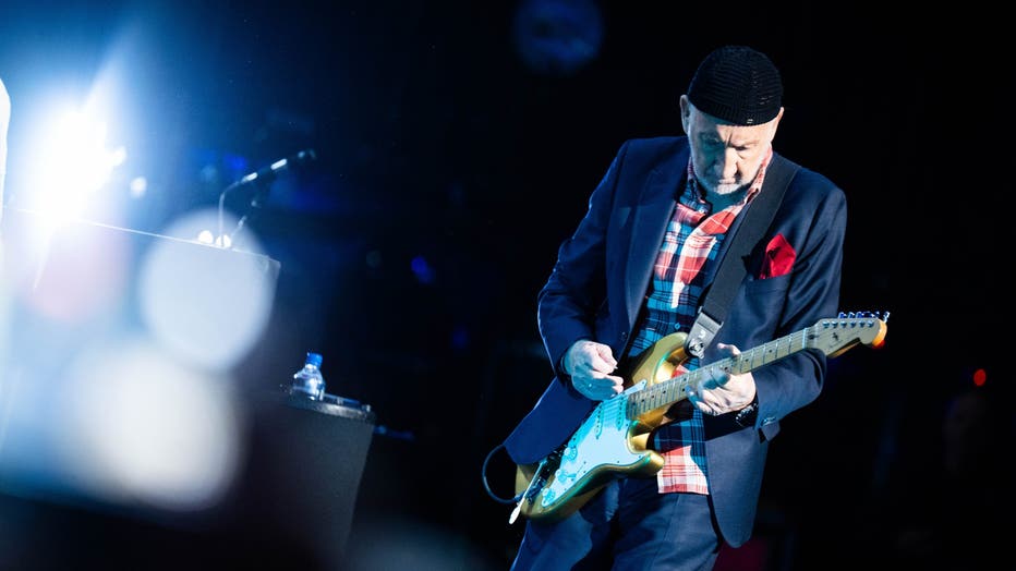 pete townshend playing a guitar on stage