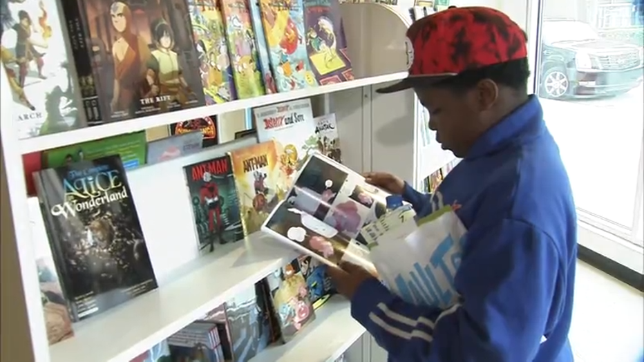 kid reading a comic book at a store