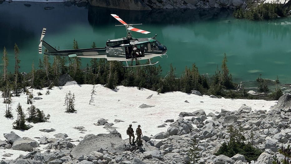 helicopter flying over lake photo