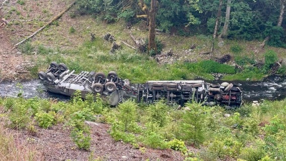 Tanker truck goes off highway, crashes and leaks fuel into WA's Indian Creek