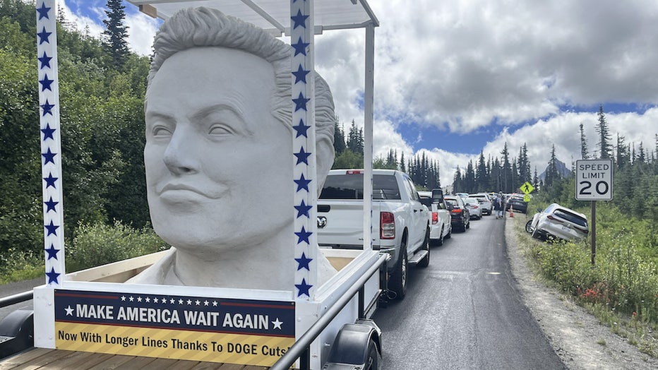 white elon musk statue in the back of a trailer