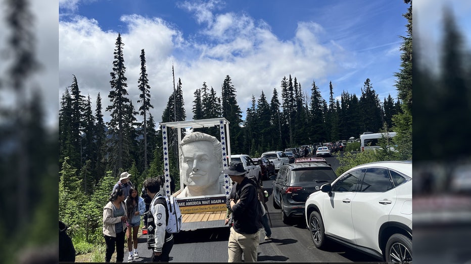 white elon musk statue in the back of a trailer
