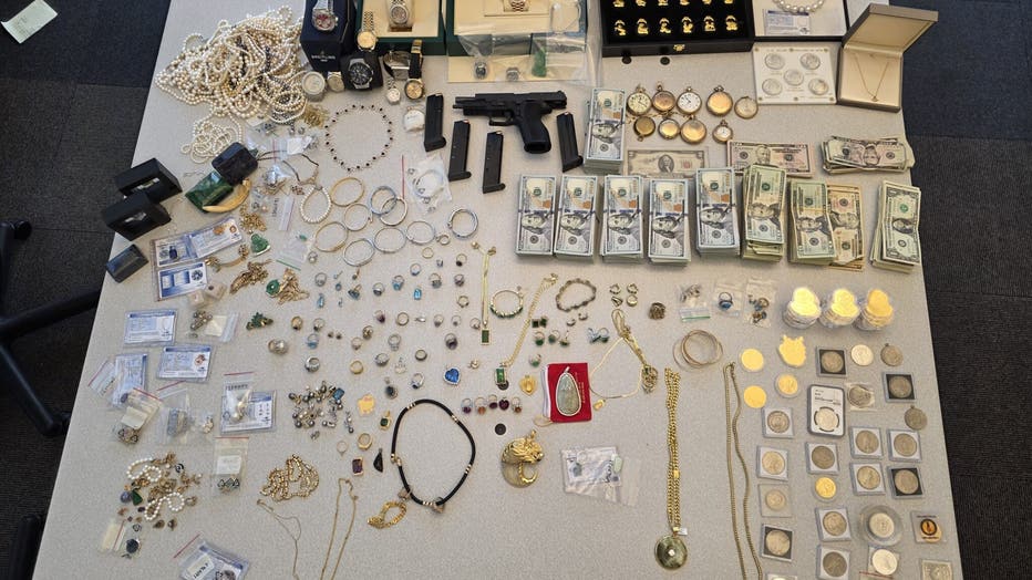 Multiple valuable jewelry items, cash, and a handgun seized by Seattle police detectives.