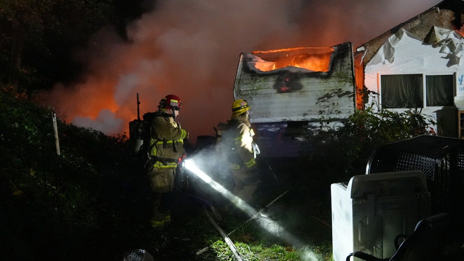 Firefighters rescued eight dogs, including six husky puppies, after an overnight fire displaced a family in Monroe early Tuesday morning. According to Snohomish Regional Fire and Rescue (SRFR), crews responded to a structure fire near 208th Place Southeast and Old Monroe Duvall Highway at around 2 a.m. Firefighters had to navigate a steep dirt road to find the home and discovered a 5th-wheel trailer and a nearby home were fully engulfed in flames. The residents had safely evacuated before firefighters arrived. Since the area lacked nearby fire hydrants, Snohomish County Fire District 4 and Duvall Fire were called in to assist in maintaining the water supply. SRFR said a primary search confirmed everyone made it out safely, but they also rescued six husky puppies and two adult huskies. 