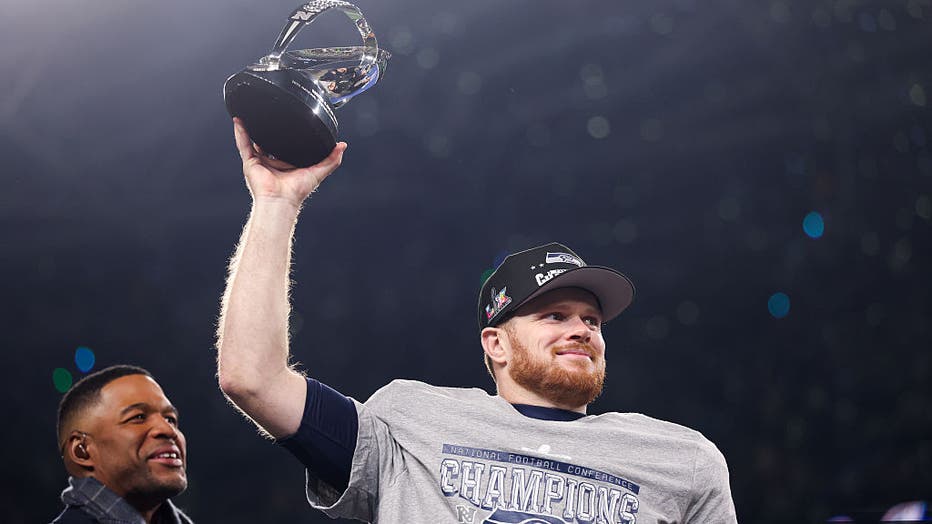 SEATTLE, WA - JANUARY 25: Seattle Seahawks quarterback Sam Darnold (14) holds onto the George Halas Trophy after winning NFC championship game against the Los Angeles Rams at Lumen Field on Sunday, Jan. 25, 2026 in Seattle, WA. (Eric Thayer / Los Angeles Times via Getty Images)