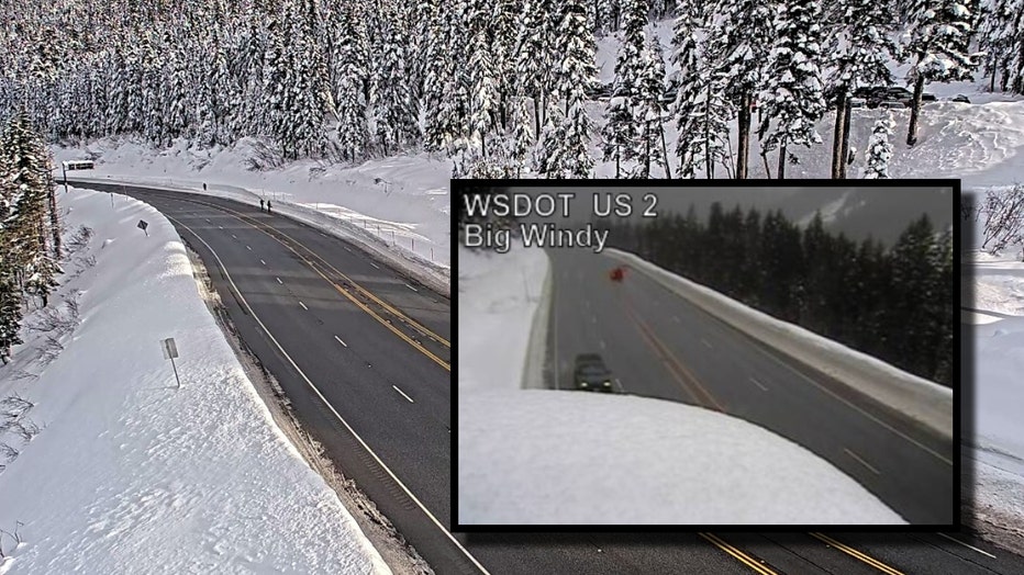 highway 2 along stevens pass is covered by snow on both sides as the clear roadway is now reopened to traffic