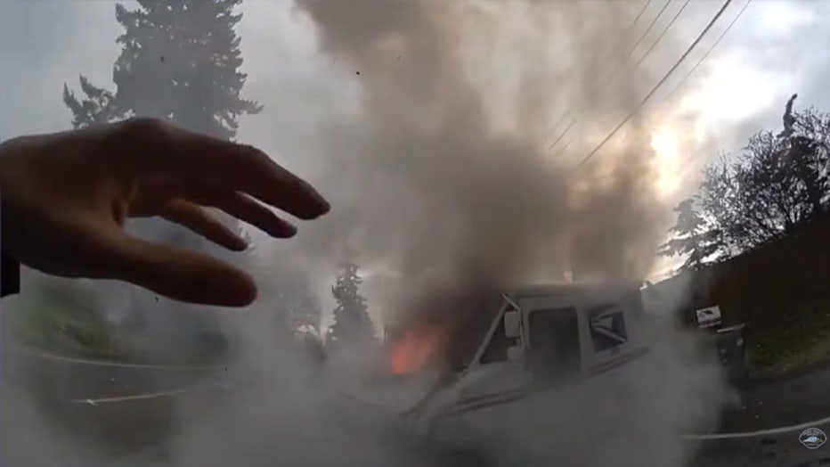 The Pierce County Sheriff’s Office (PCSO) released new bodycam video of deputies responding to a mail truck that caught fire after a crash earlier this month. On Jan. 10, just after noon, deputies responded to reports of a mail truck on fire after colliding with a sedan near the corner of Park Avenue South and 106th Street South in Tacoma. The first deputy to arrive at the scene saw the U.S. Postal Service truck driver injured and in danger due to the fire. The deputy immediately pulled him away from the burning truck before attempting to extinguish the flames with the help of a female bystander. Authorities said both the mail truck driver and the back-seat passenger of the sedan were injured and transported to nearby hospitals in serious condition. The PCSO thanked Central Pierce Fire and the female bystander for their assistance. Further information about what led up to the crash is limited at this time.