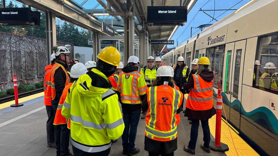 sound transit crews stand at the site of mercer island light rail station