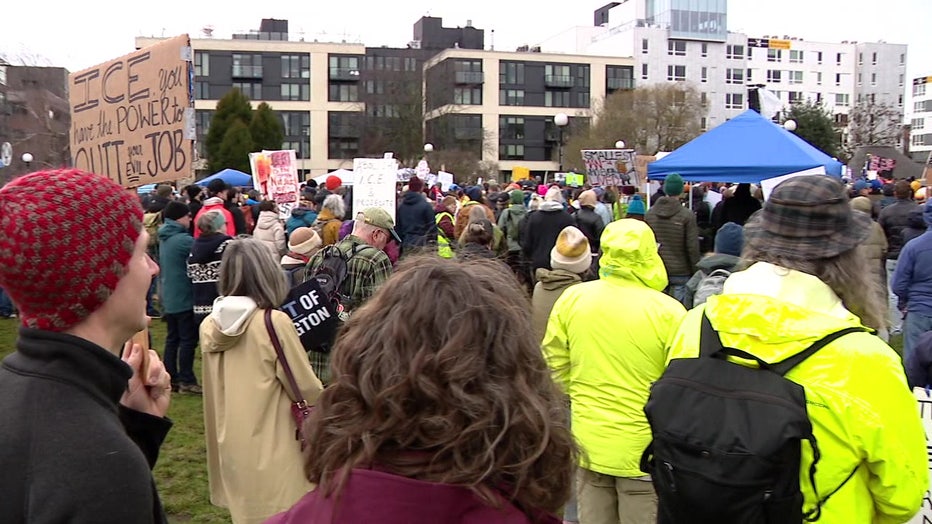 protesters gather in a crowd in seattle's cal anderson park to protest ice tactics 