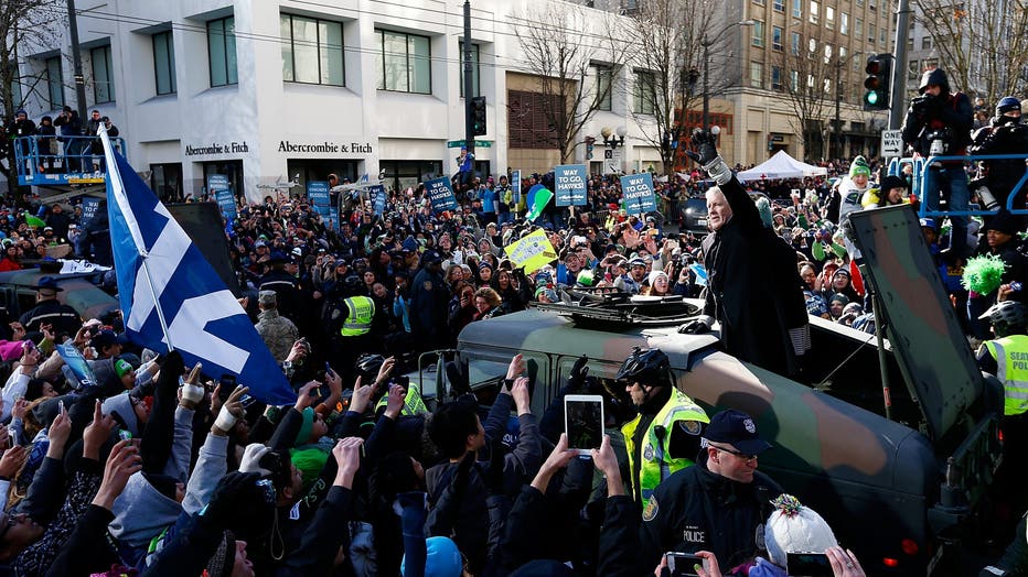 pete carroll waves to fans during super bowl parade