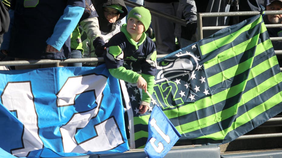 young boy with 12 flag and seahawks gear
