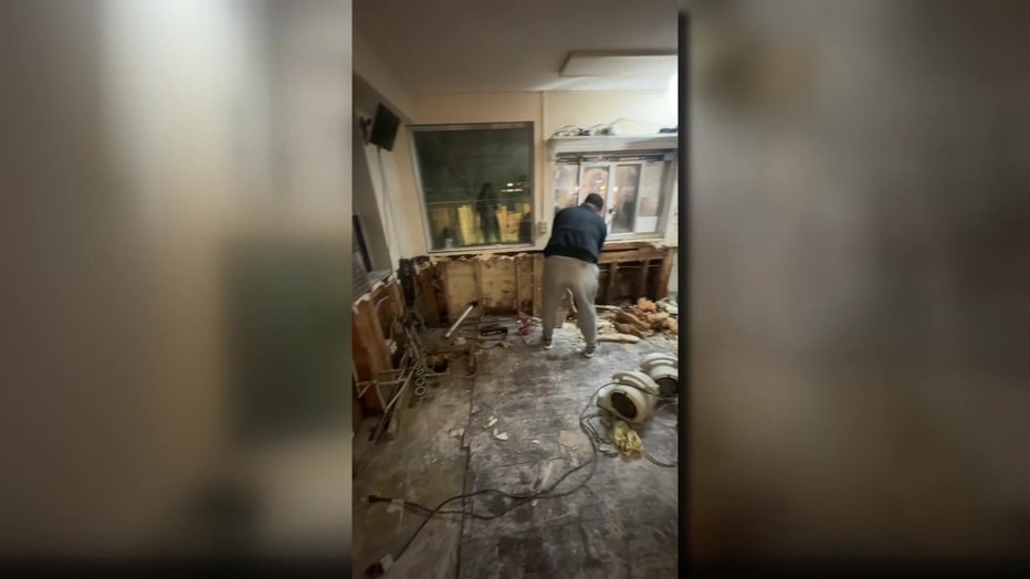 hashem’s family, friends and team members work to repair flood damage at their auburn shop following devastating regional flooding during a december atmospheric river event
