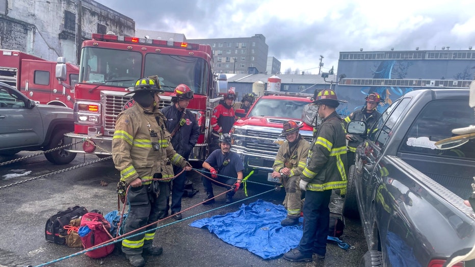 rescue teams in tacoma help save a driver dangling over a 20-foot concrete drop